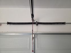 Old broken spring, garage door torsion spring.