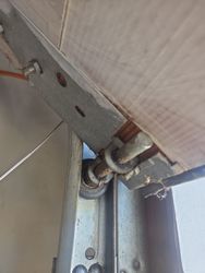 Old chewed up rusty garage door rollers.