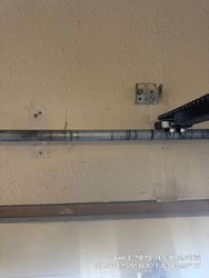 Old operator bracket loose and sinking into the wall