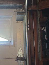 No gap on the right side of the door. Shows how far the door and tracks are misaligned. Misalignment will cause components to fail sooner rather than later. 