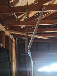Improper hanger installation is causing premature roller ware and they will eventually break. Sooner rather than later. 
