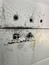 This is what happens to the overhead doors with the half hinge on them. The 27 gauge metal on the backing starts to crack.