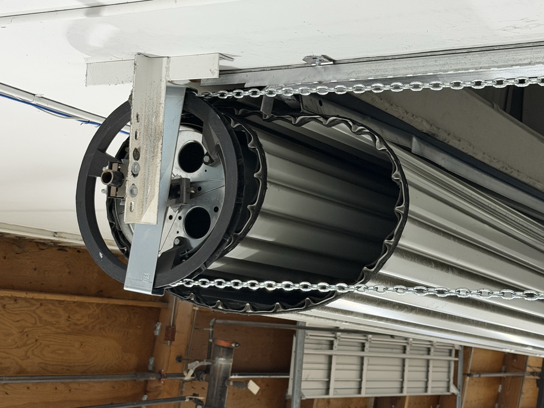 Commercial rolling steel door drum and chain hoist assembly during service