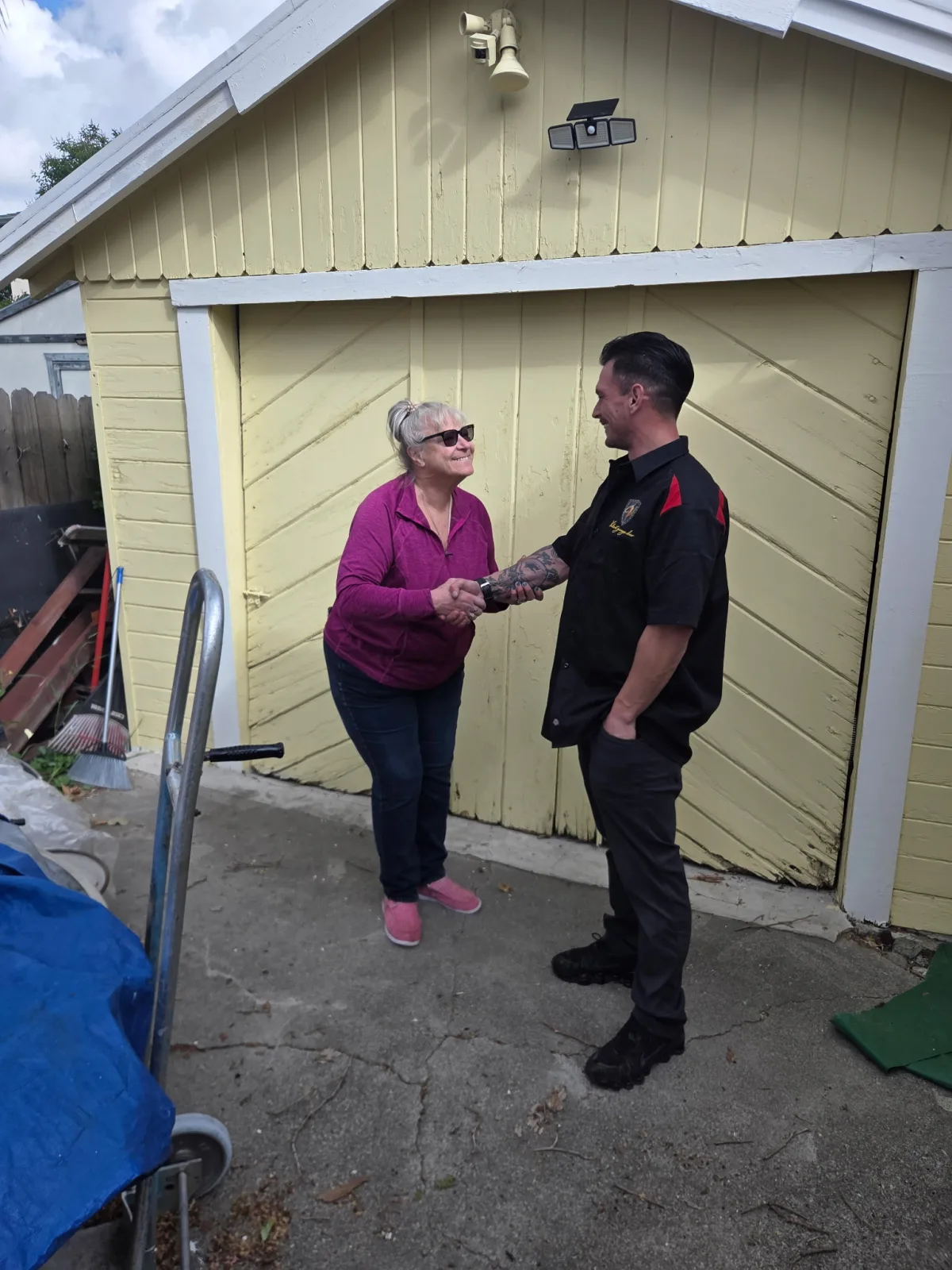 Valentino Ramirez with community garage door project recipient