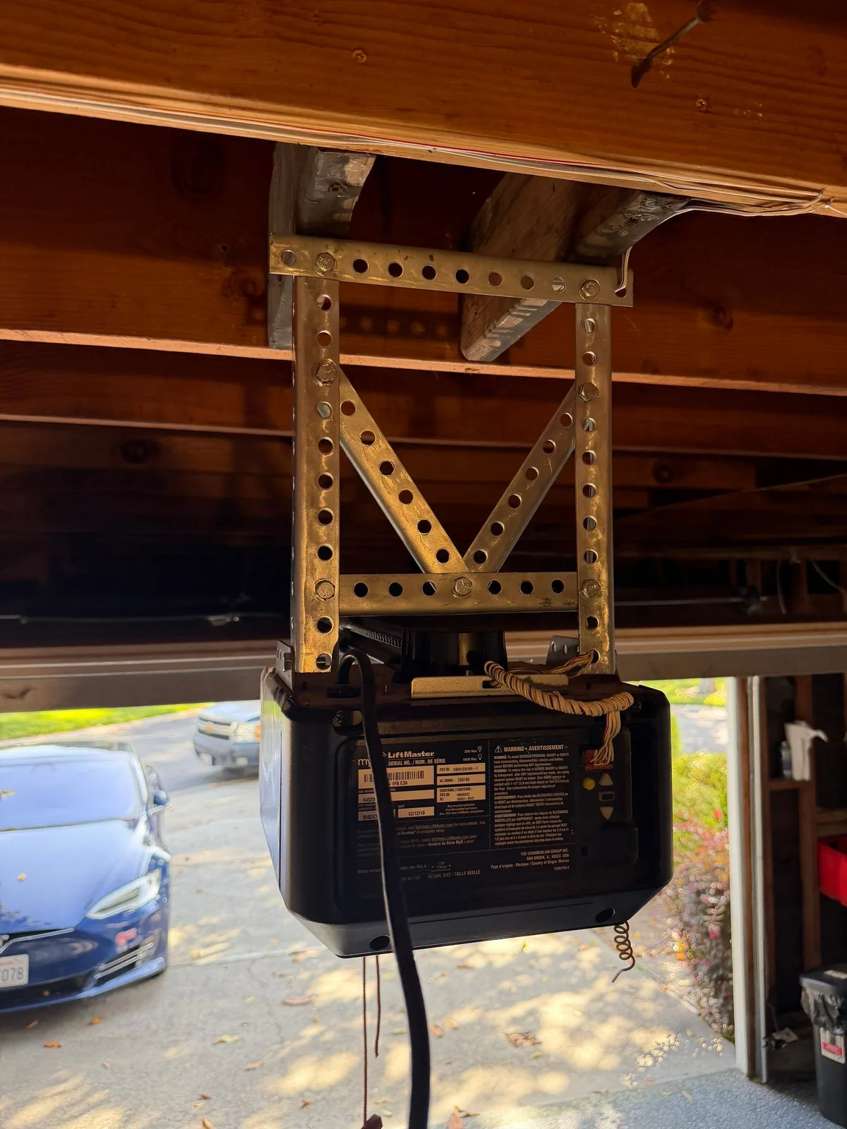 New V-style garage door opener mount with cleaner overhead wiring.