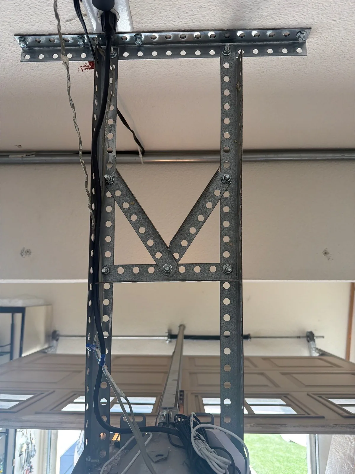 Reinforced V-style garage door opener support structure.