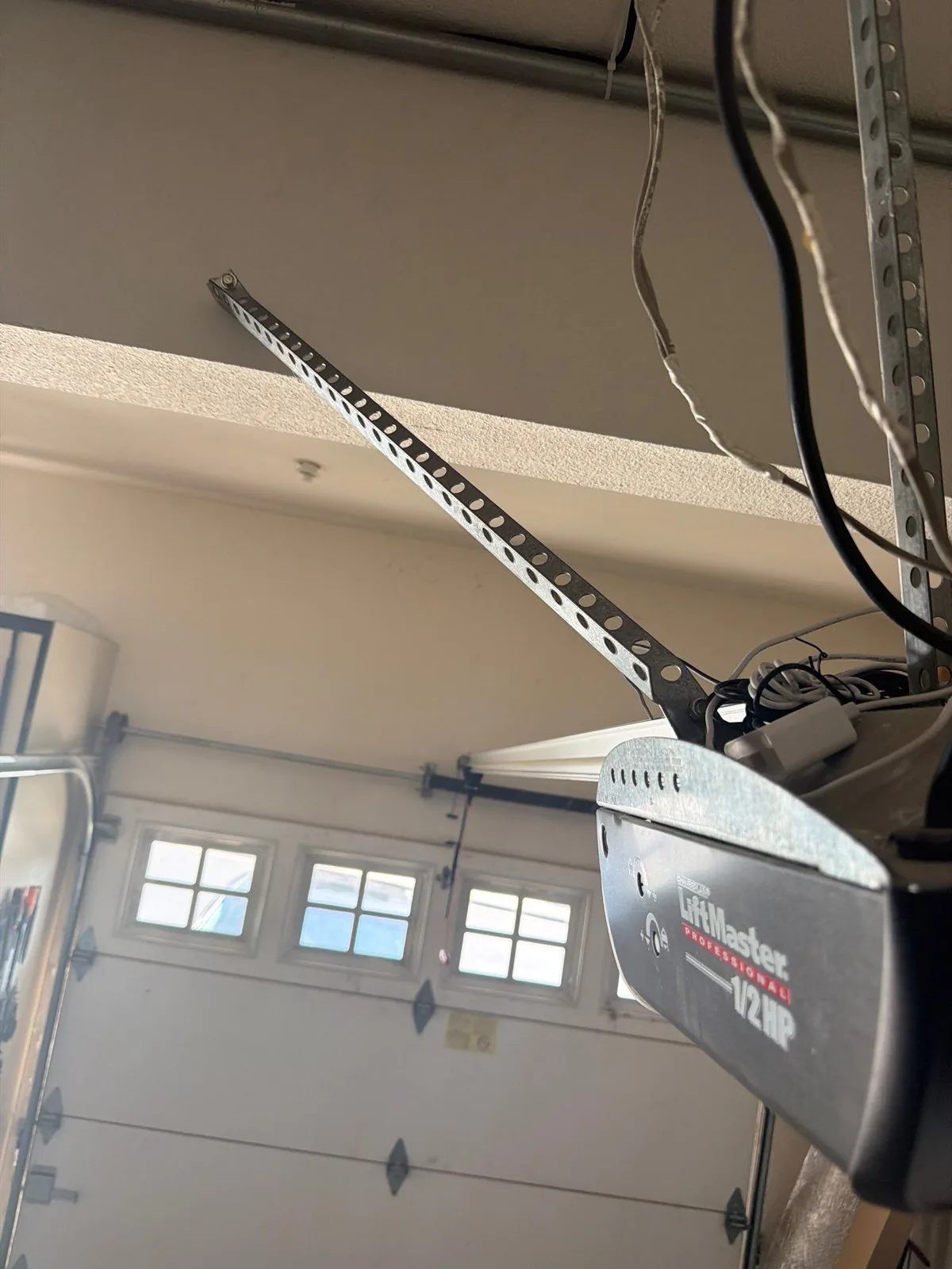 Old garage door opener mount and overhead support hardware.