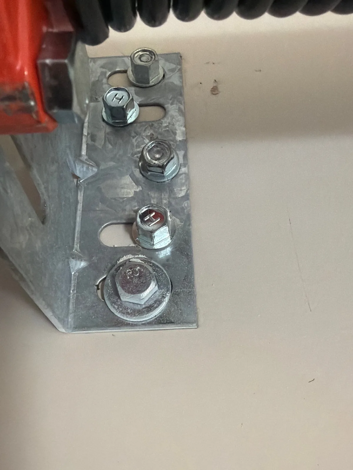 New garage door center support plate secured with multiple lag fasteners.
