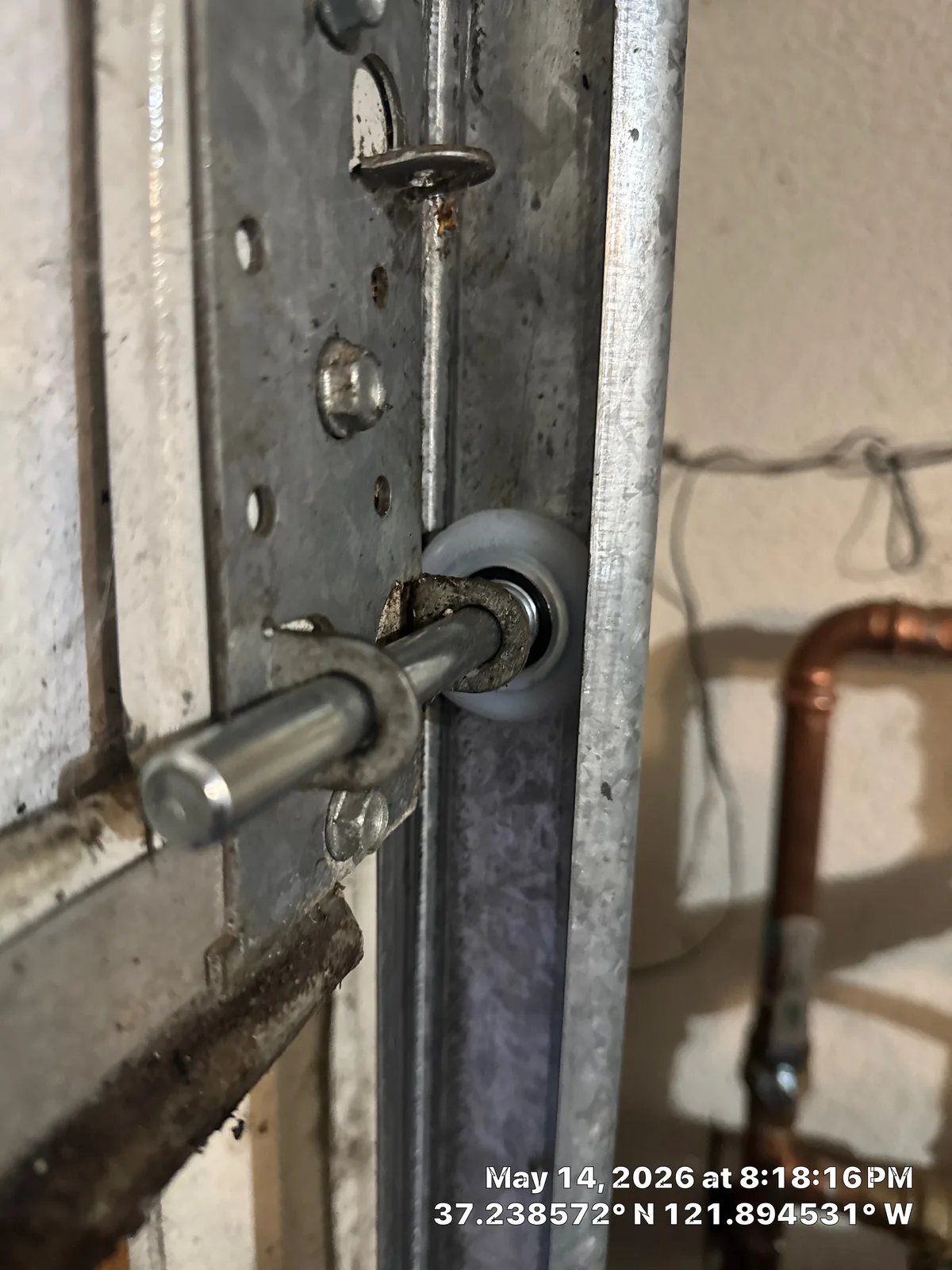 New garage door roller installed at the track hardware.