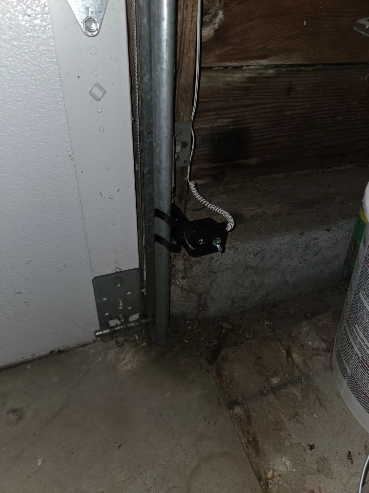 New garage door safety sensor mounted near the lower track.