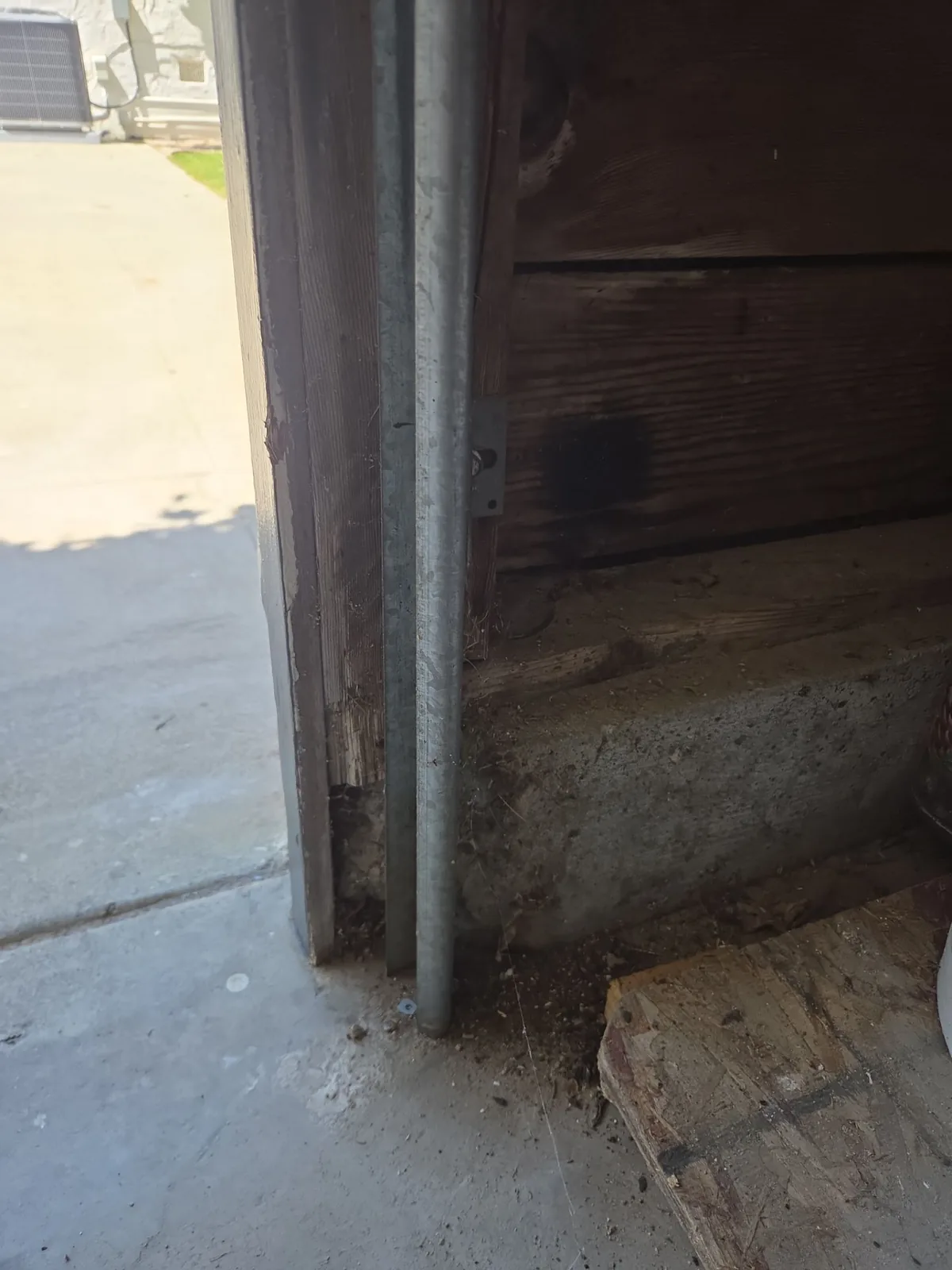 Existing garage door safety sensor near the lower track.