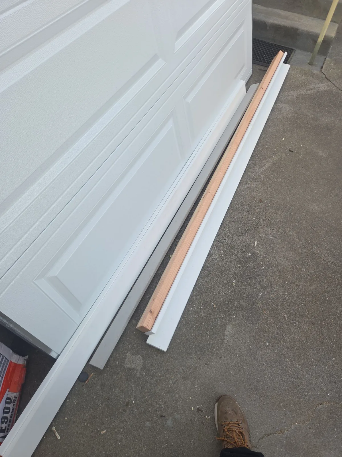 New white exterior trim installed beside a garage door.