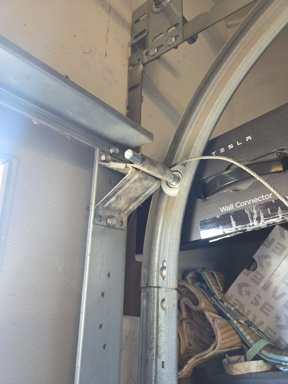 New garage door roller hardware installed at the upper track.