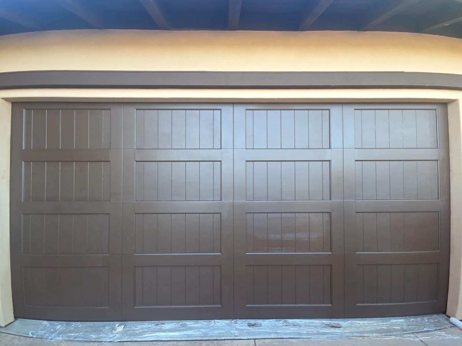 Garage door panels after a refreshed painted finish was applied.