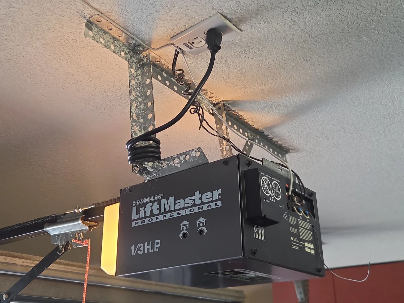 Older LiftMaster garage door opener mounted near the ceiling.