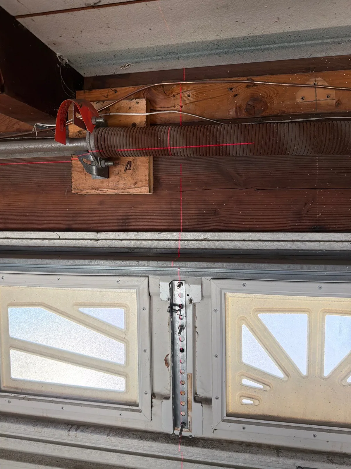 Older garage door torsion hardware above the door.
