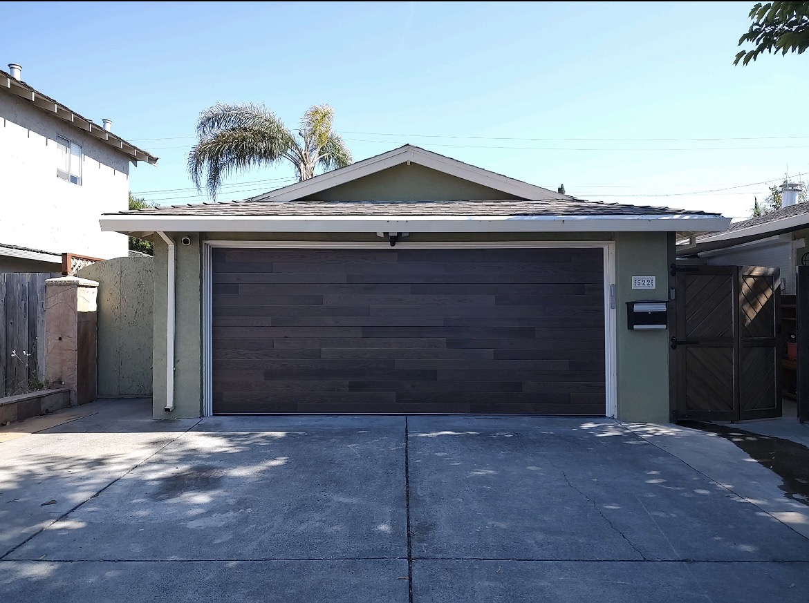 modern dark flush panel garage door fabricated by Valiant Garage Door