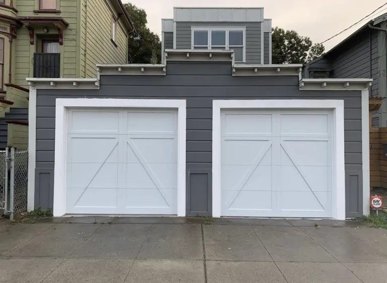 After garage door installation with white carriage-style doors
